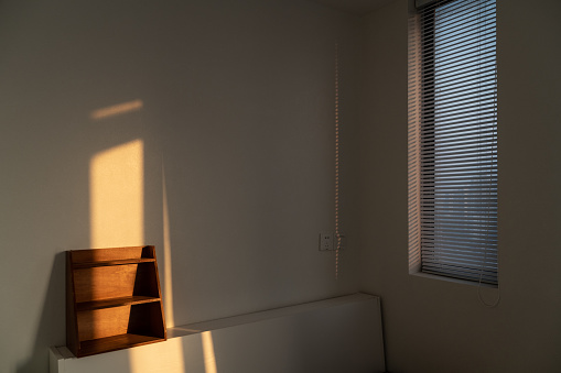 The sun shines through the window in the bedroom