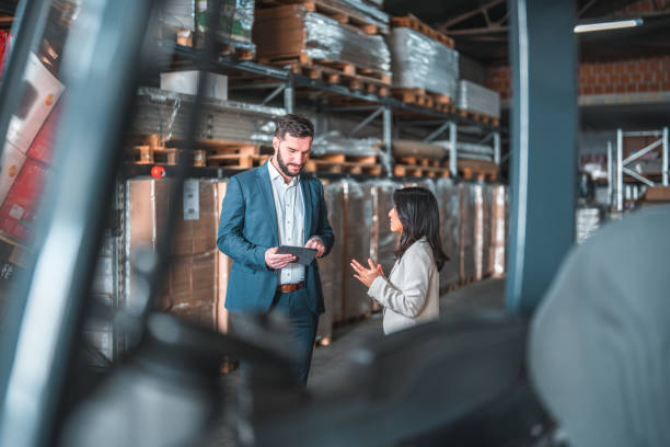 istock Successful Caucasian Businessman Using A Digital Tablet In A Warehouse 1473416730