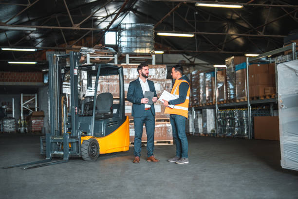 istock Two Multiracial Males Standing In A Warehouse, Discussing Business Matters 1473416780