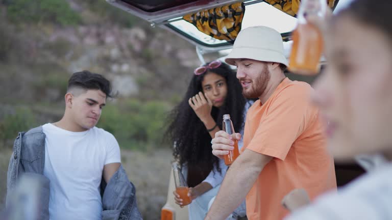 Young friends having a celebration on retro mini van transport