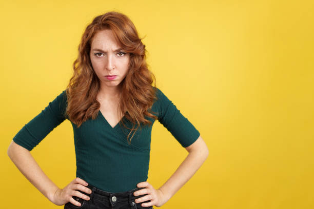 istock Redheaded woman looking at camera with an angry expression 1473418270