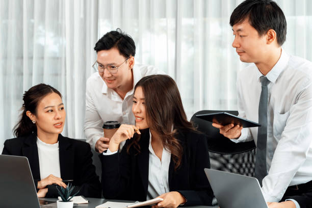 istock Office worker and manager analyze financial report paper in harmony workplace. 1473419105
