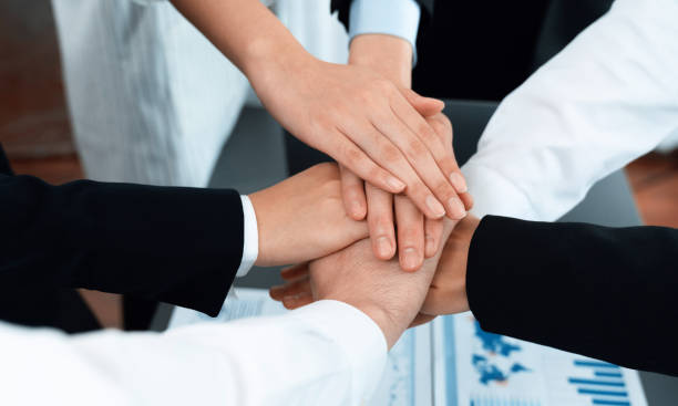 istock Top view closeup business team join hand stack together for harmony concept. 1473419154