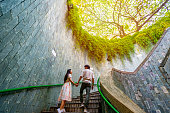 Young couple traveler with giant tree at Fort Canning Tree Tunnel in Singapore
