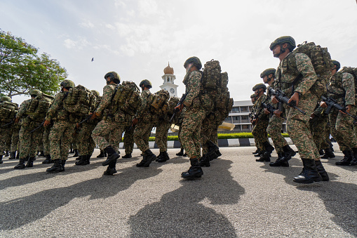 George Town, Penang, Malaysia - Aug 29 2022: Shadow of soldier procession at street during Independence day