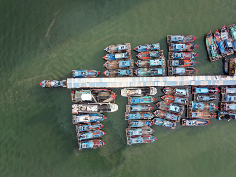 Batu Maung, Penang, Malaysia - Aug 30 2022: Aerial top down view fisherman boat park at jetty