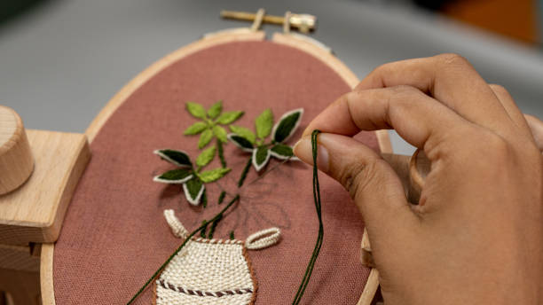 istock Crafters making Hand Embroidery and flowers vase 1473423456