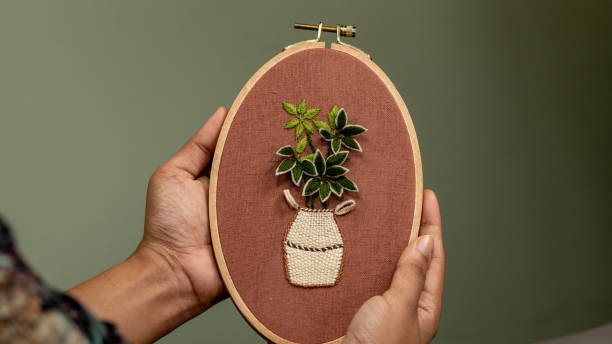 istock Hand's showing Hand Embroidery and flowers vase 1473423458