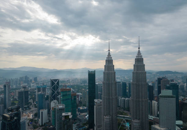 petronas twin towers in sun ray morning - business malaysia bildbanksfoton och bilder