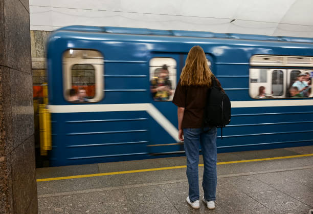 istock a girl with a backpack is waiting for a train at the station 1473425195