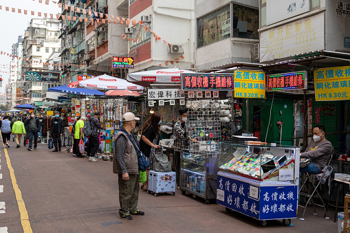 Hong Kong - March 13, 2023 : People at the flea market in Sham Shui Po, Kowloon, Hong Kong.