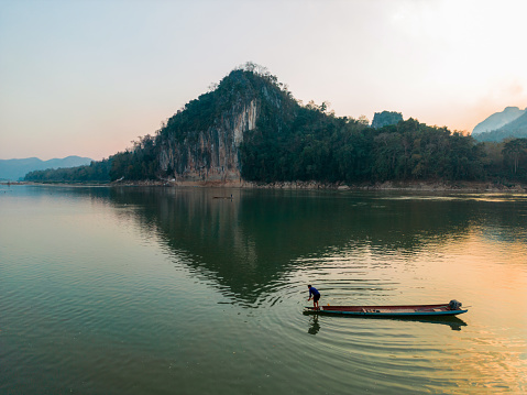 Scenic aerial view of boat on Mekong River at sunset