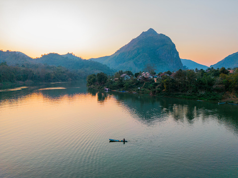 Scenic aerial view of boat on Mekong River at sunset