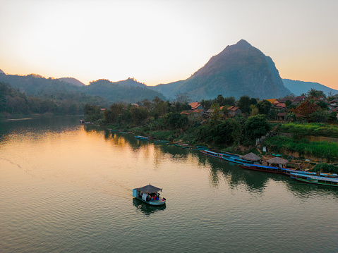 Scenic aerial view of boat on Mekong River at sunset
