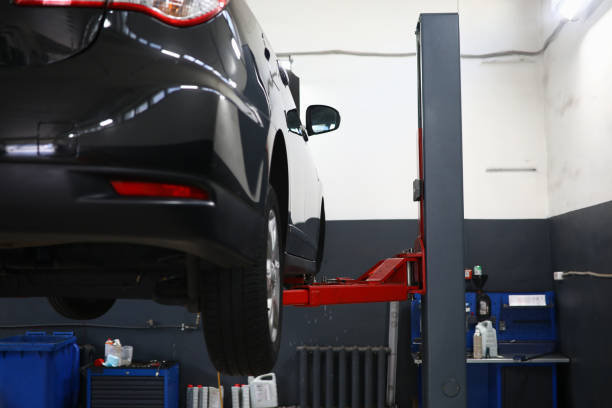 istock Modern car on lift in service center 1473428093