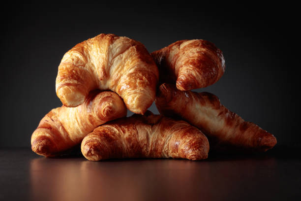 istock Freshly baked croissants on a black ceramic table. 1473430701