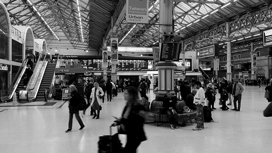London, UK - Circa November 2022: People at Victoria Station in black and white