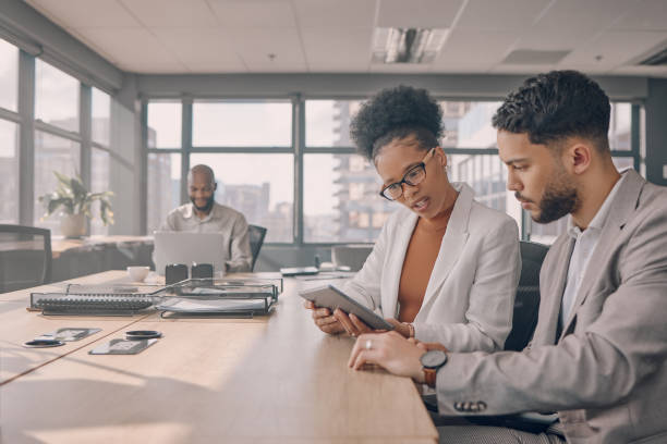 istock Office conversation, tablet teamwork and black people collaboration on online project together. Strategy, planning and web analytics report of a business team looking at a digital checklist and data 1473432558