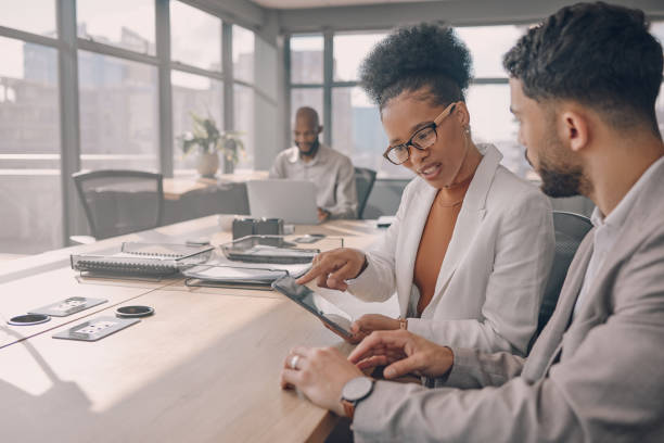 istock Office communication, tablet teamwork and black people working on a online project together. Strategy, planning and web analytics report of a business team looking at a digital checklist and data 1473432559