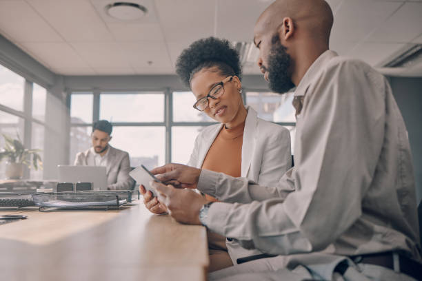 istock Office collaboration, tablet teamwork and black people working on a online project together. Strategy, planning and web analytics report of a business team looking at a digital checklist and data 1473432584