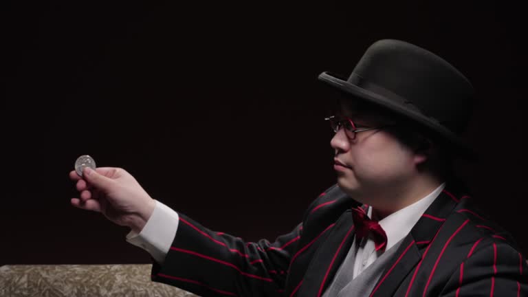 Close-up shot of a magician performing coin tricks