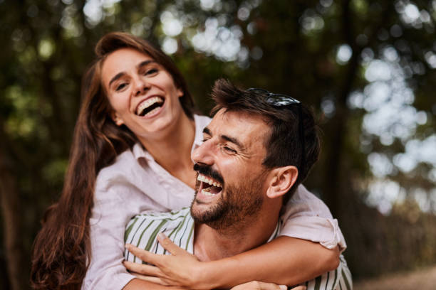 istock Cheerful couple having fun while piggybacking in nature. 1473435988