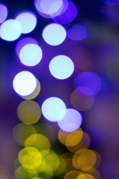 istock Abstract multicolored bokeh on a dark background. Beautiful vertical background with colorful bokeh on a black background 1473436340