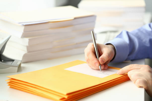 istock Businessman is preparing parcel for delivery at table in office 1473437424