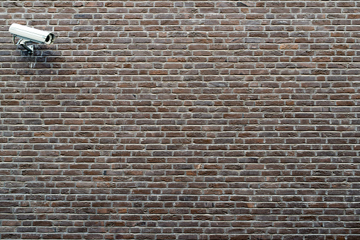 Brick wall background with spotlights reflection. Brick wall texture illuminated with spotlights in the dark