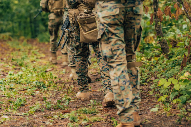 istock Modern warfare Soldiers Squad Running as Team in Battle Formation 1473440965