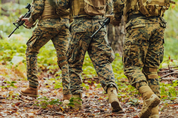 istock Modern warfare Soldiers Squad Running as Team in Battle Formation 1473441018