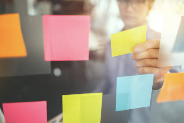 istock Business people brainstorming putting sticky note on glass wall, Selected focus. 1473442202