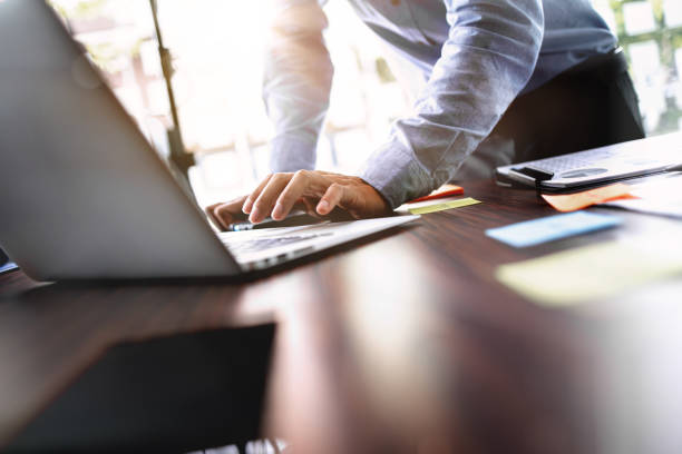 istock Business executive using laptop at meeting in modern office. 1473442252