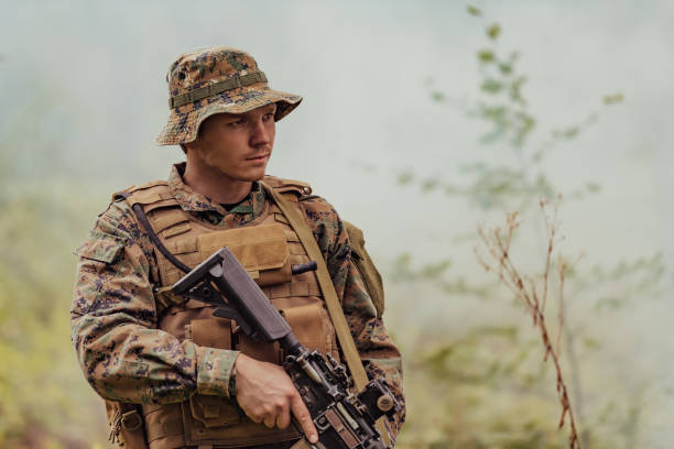 istock A soldier fights in a warforest area surrounded by fire 1473443018