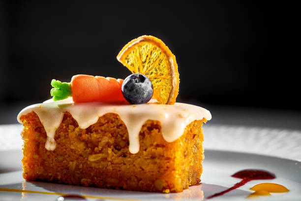 Carrot-orange cupcake on a plate with sauces. Hard light. Carrot cake stock photo