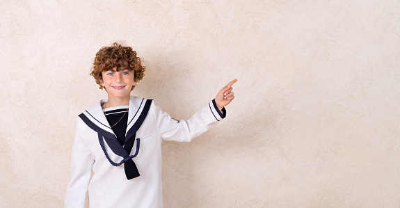 Spanish boy making and celebrating la primera comunión in the church