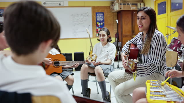 Smiling female educator teaching music class