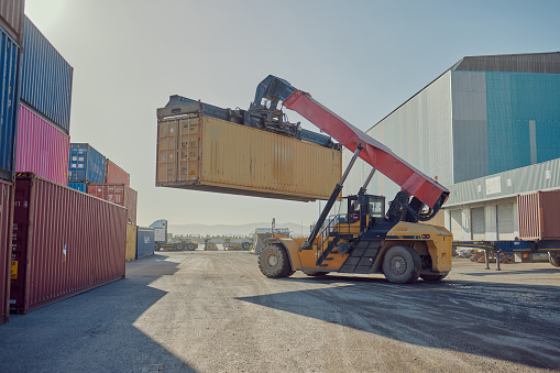 Delivery, forklift or truck loading container at manufacturing supply chain for stock or packages outside. Warehouse or ecommerce cargo lifting for transportation or freight shipping distribution
