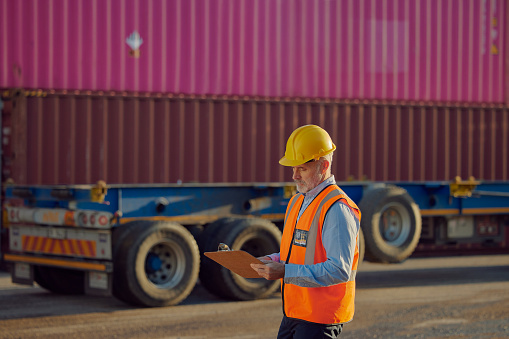 Industry man, clipboard and freight truck, shipping container or cargo, supply chain management and logistics inspection. Commercial transport, industrial person checklist and business export service