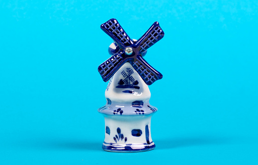 Vintage windmill figurine from Holland, isolated on blue