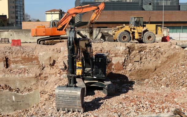 istock Two excavators and a bulldozer during a redevelopment of an urban area. 1473446794