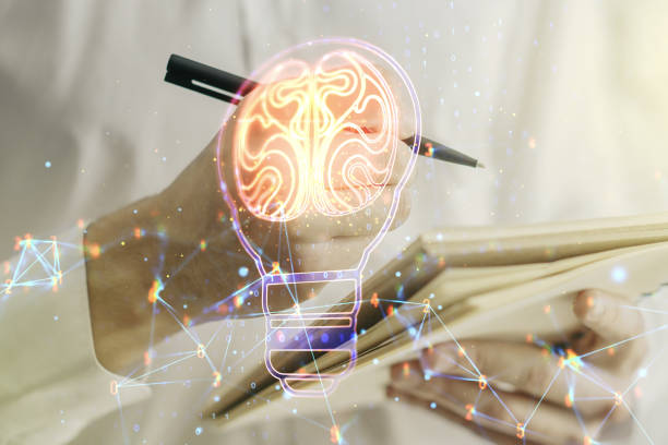 istock Creative idea concept with light bulb and human brain illustration with man hand writing in notebook on background. Neural networks and machine learning concept. Multiexposure 1473449944