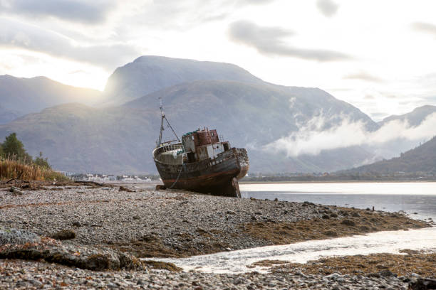 istock Old abandoned boat at the side of a loch 1473449983