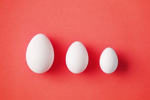 Eggs on red background. Horizontal composition with copy space.