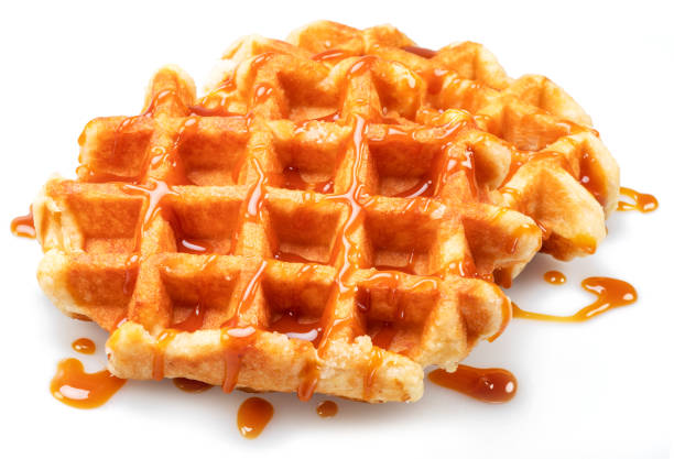 istock Belgian waffle with caramel topping isolated on white background. 1473450987