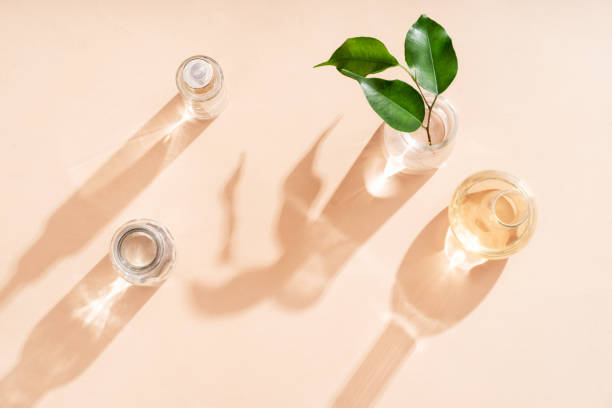 istock Cosmetic glass jars and flasks in the rays of sunlight shadow falling on the background. Cosmetic background. Flat style. 1473452217