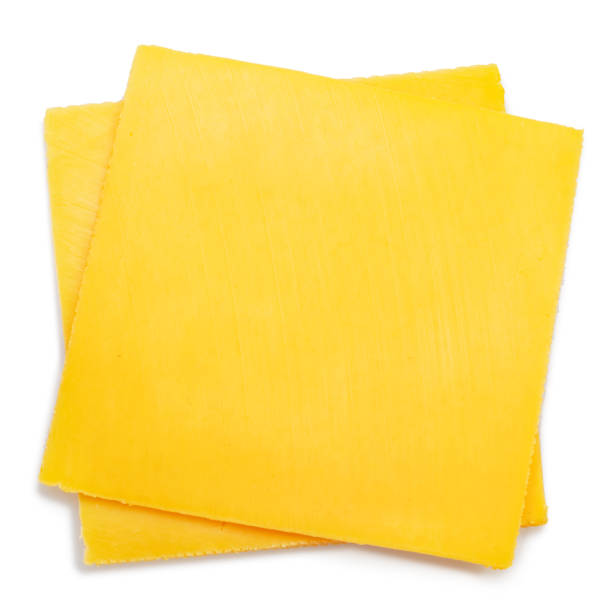 istock Square slices of meltable cheese, popular cheeseburger ingredient on white background. 1473452679