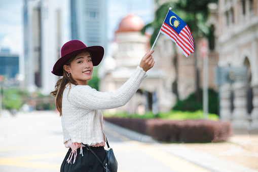 A young Malaysian woman proudly display her patriotic spirit and solidarity in celebrating the National Day at Merdeka Square, Kuala Lumpur Malaysia.