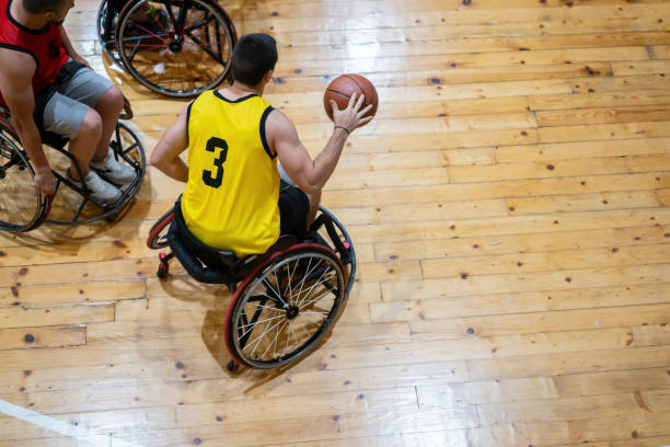 istock Disabled athletes in action playing basketball 1473453443