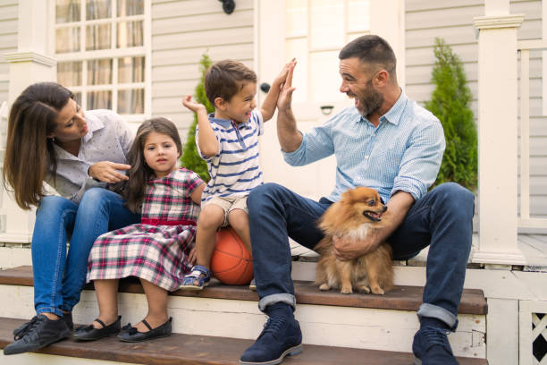 istock A family of four on the front steps 1473453600